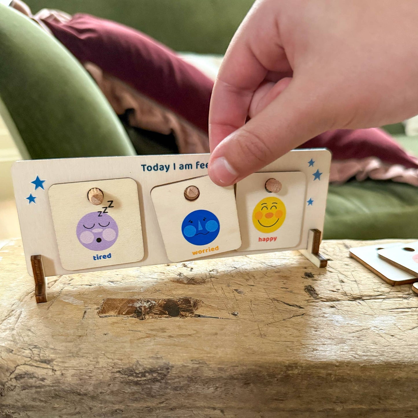 Kids' emotion chart and mood board. Wooden stand shows 'Today I am Feeling' with interchangeable tiles for tired, worried, and happy. Educational toy for social-emotional learning.