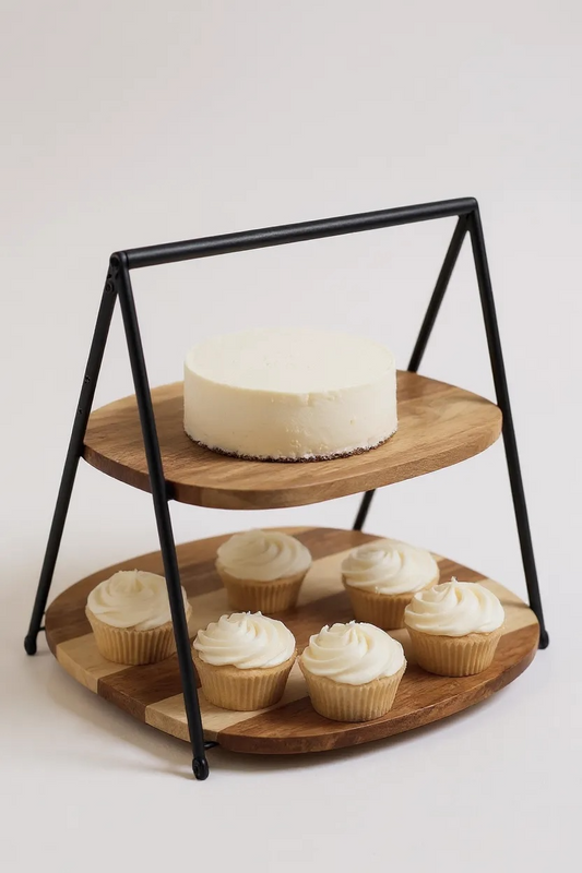 Two tier acacia wood cake stand with cupcakes and a cake