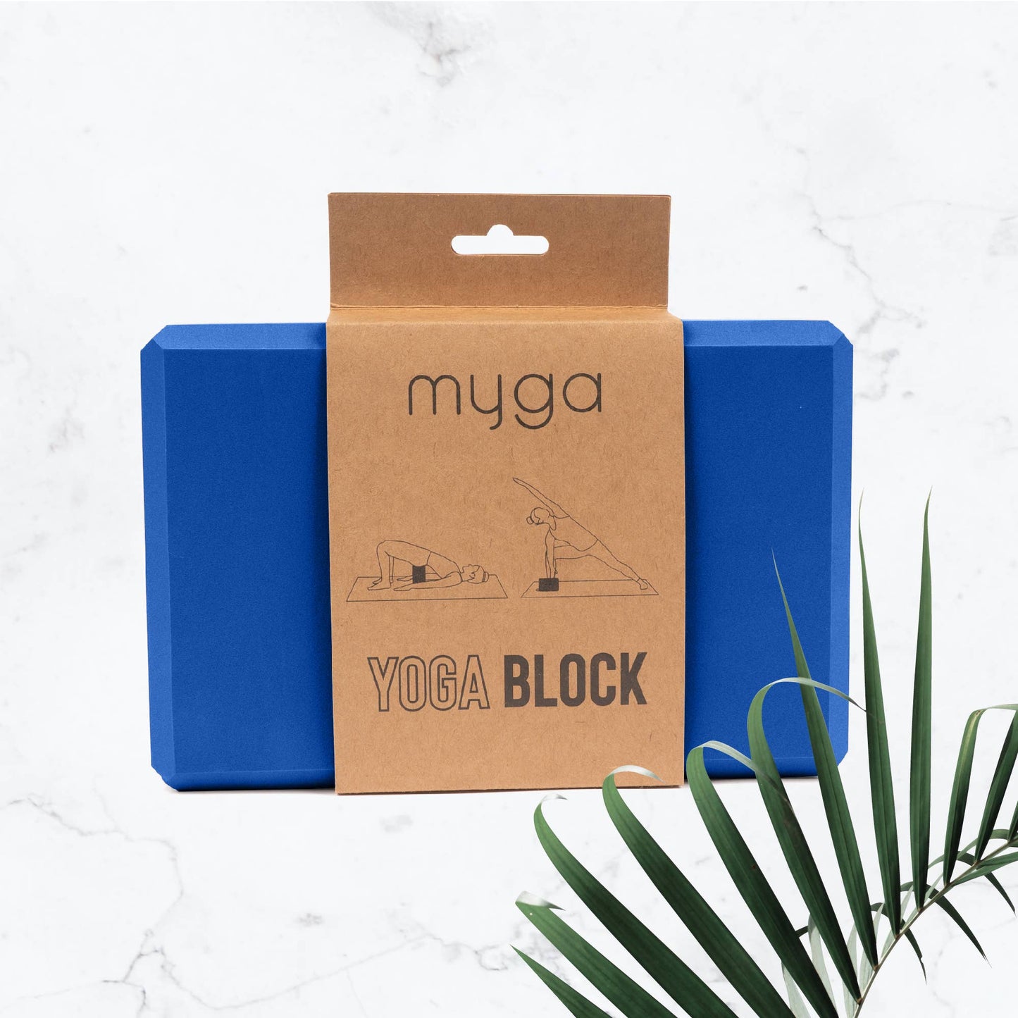 Blue yoga block with brown packaging labeled 'myga' on a white background with a plant leaf.