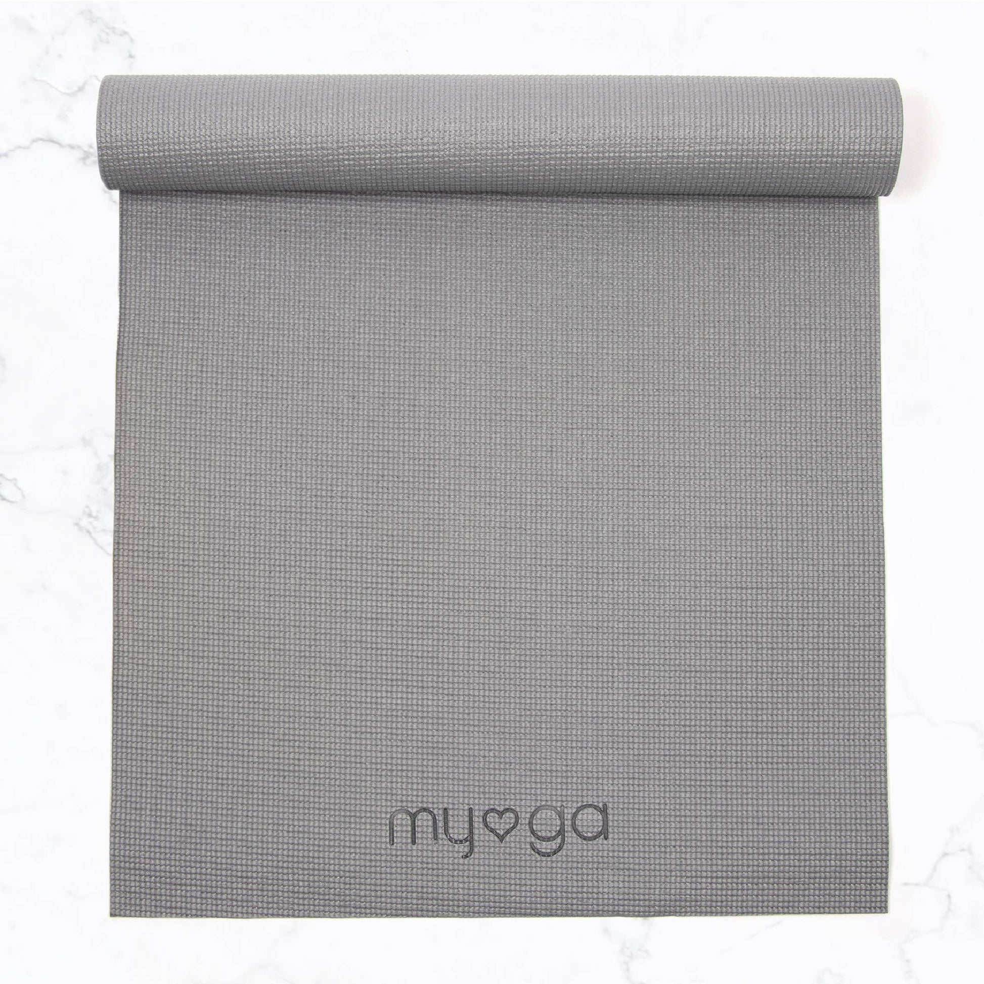Overhead view of a partially rolled, light grey Myga yoga mat. The mat has a textured surface and the Myga logo is embossed near the bottom, showing the full length and material detail.