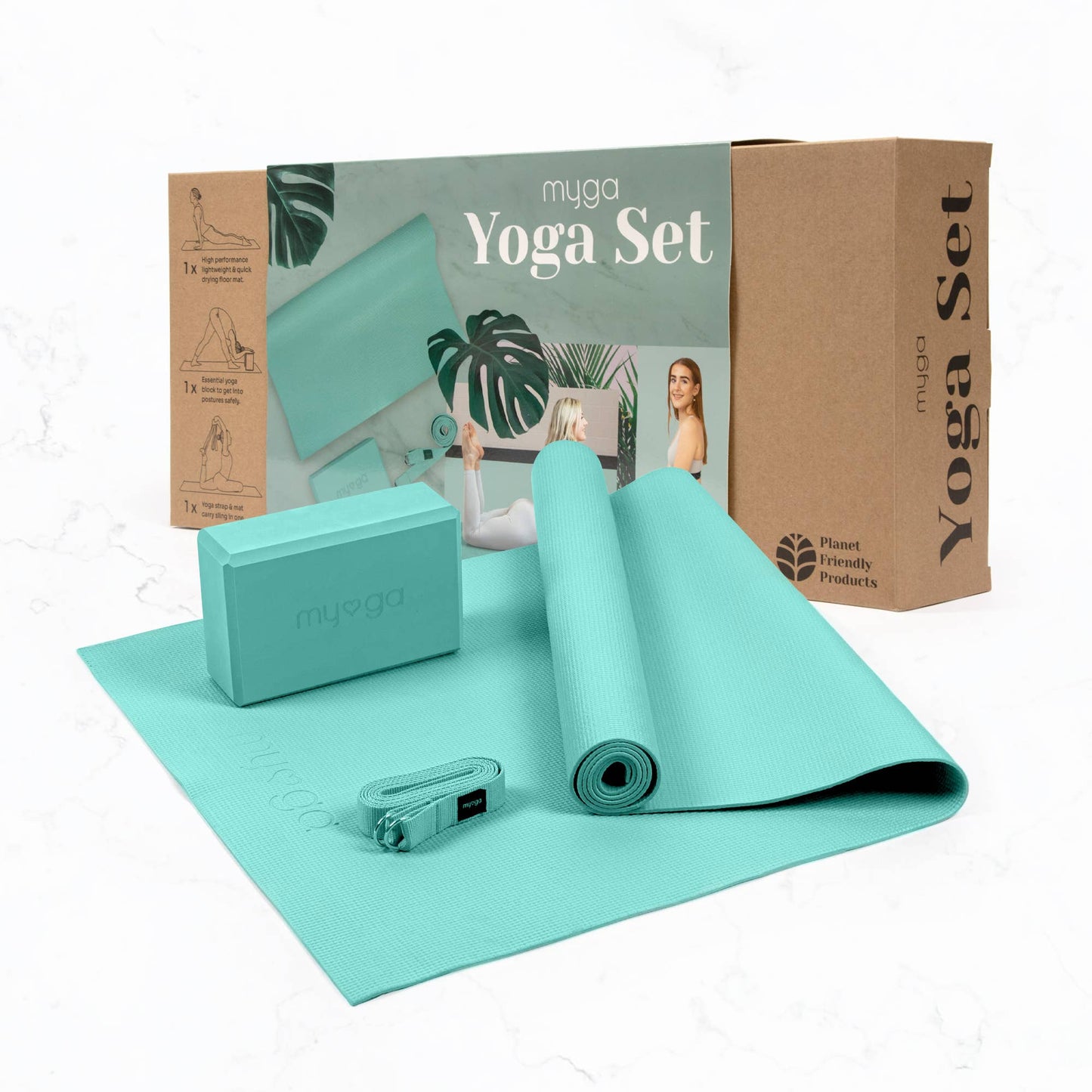 The Myga 3-piece Yoga Set in teal/mint green is displayed in front of its cardboard retail box. The set includes a rolled yoga mat, a foam yoga block, and a yoga strap, highlighting a complete, planet-friendly yoga accessory kit.