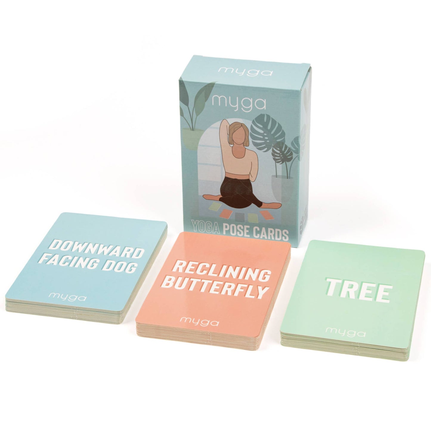 The Myga Yoga Pose Cards set, featuring the retail box and three individual cards face-up. The cards show the names of the poses: Downward Facing Dog, Reclining Butterfly, and Tree Pose, highlighting the instructional content for yoga practice.
