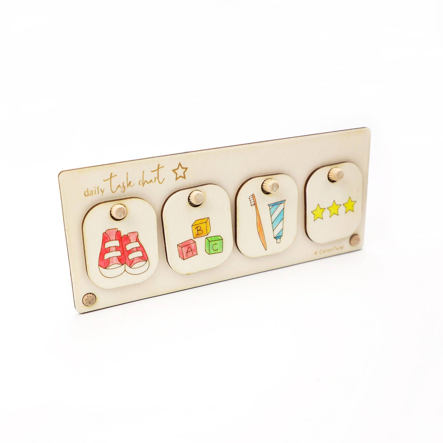The wooden Daily Task Chart display stand holding four hand-colored chore tokens: putting on shoes, playing with blocks (or learning), brushing teeth, and a star reward token. The chart is a completed, customized visual aid for a child's routine.