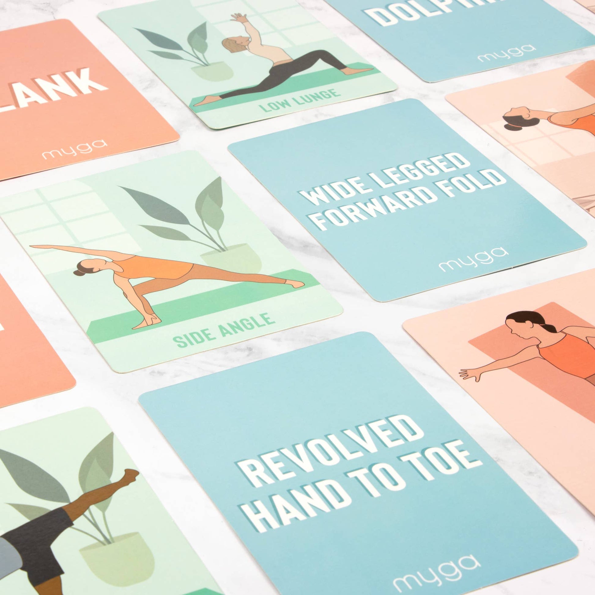A close-up view of multiple Myga Yoga Pose Cards featuring illustrations and pose names, including Low Lunge, Side Angle, Wide Legged Forward Fold, Revolved Hand to Toe, and Plank. The cards are instructional tools for practicing different yoga postures.